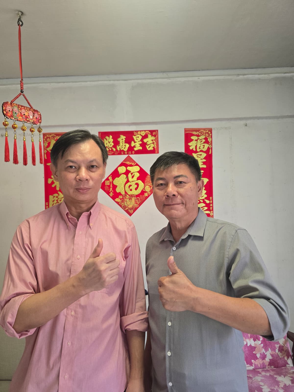 Jason from A1 Electrician SG with a happy customer in their Singapore home (1)