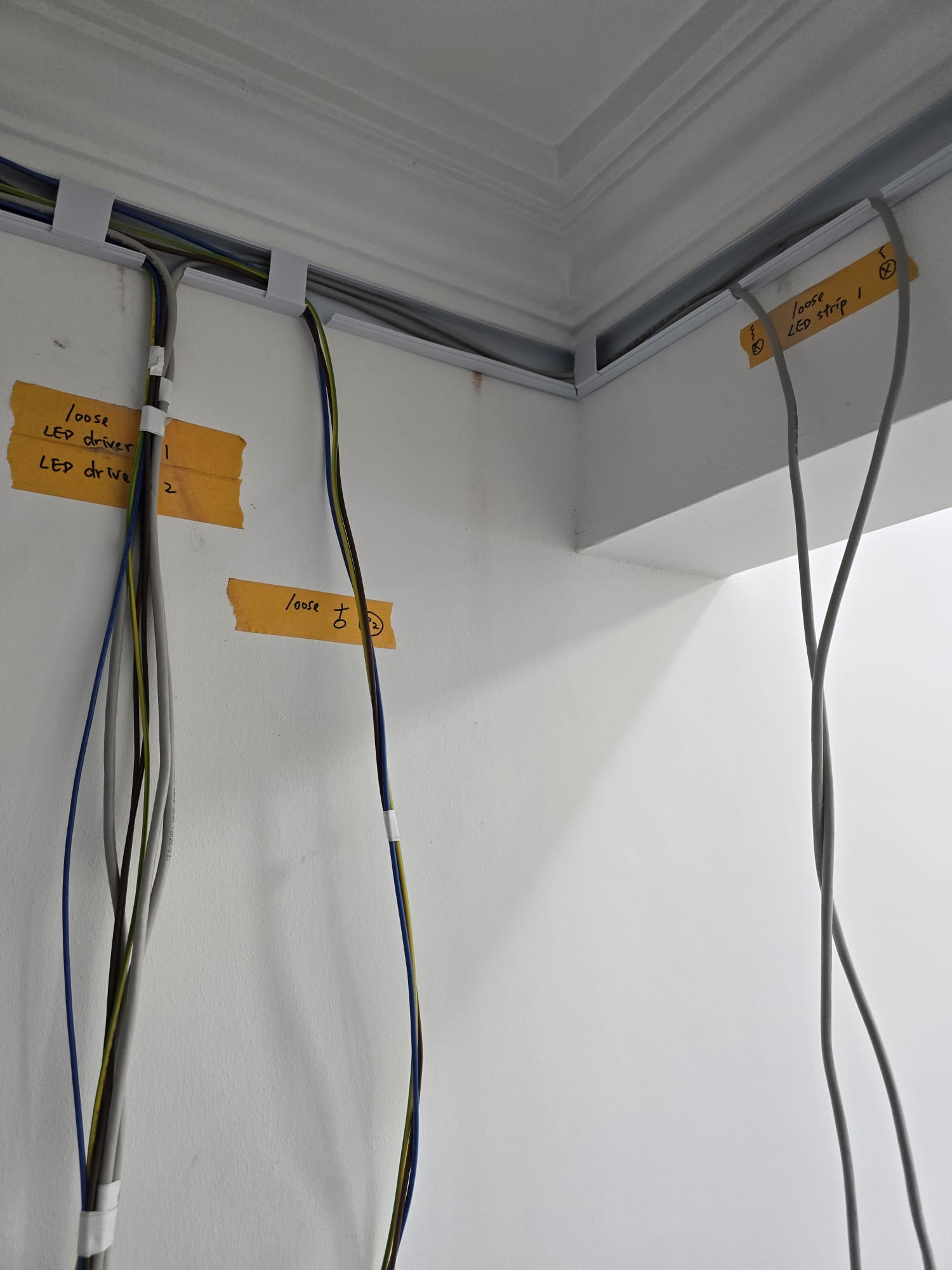 Neatly labelled LED driver and lighting cables in white trunking